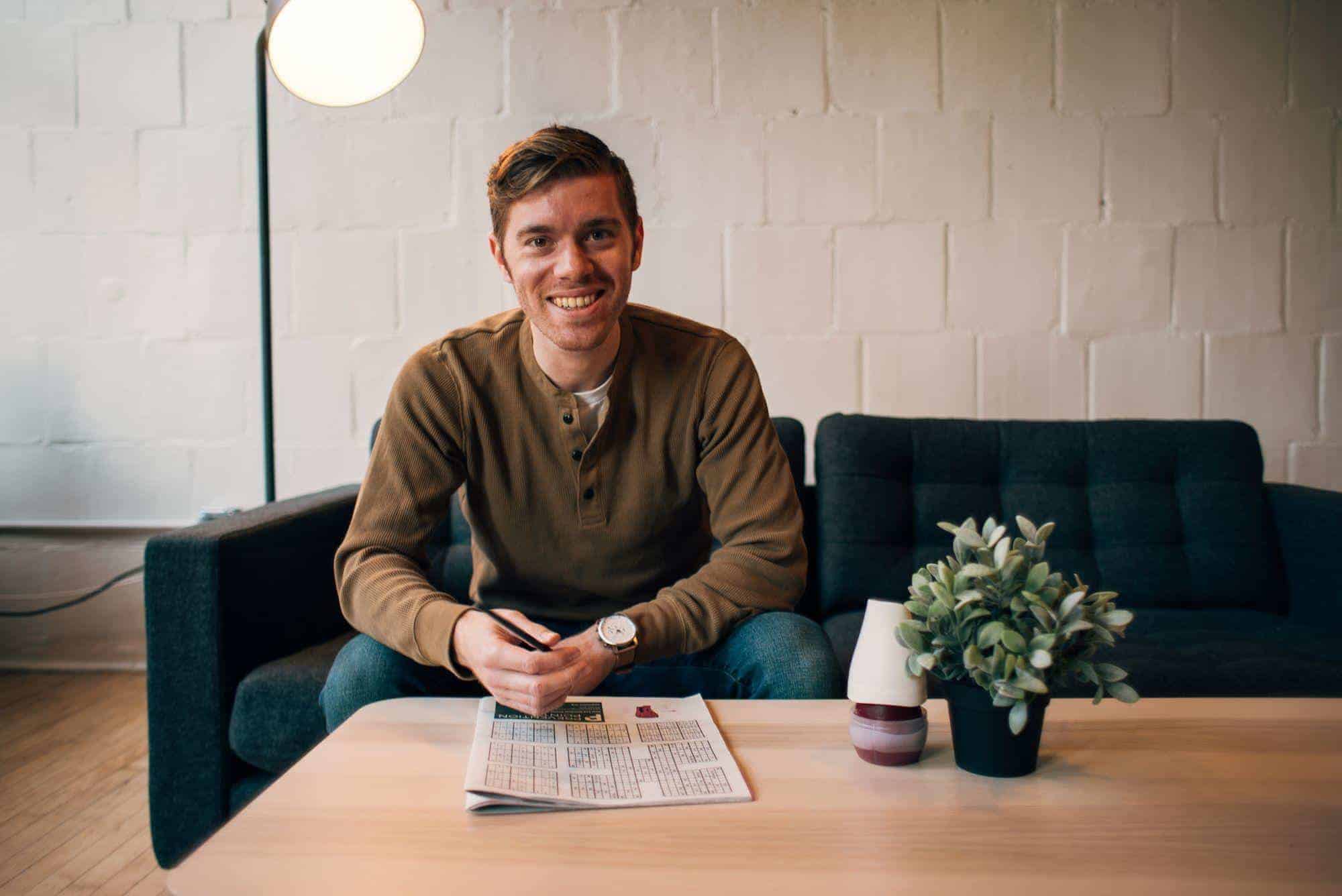 Ben Sibley of Independent Analytics sitting on a couch.